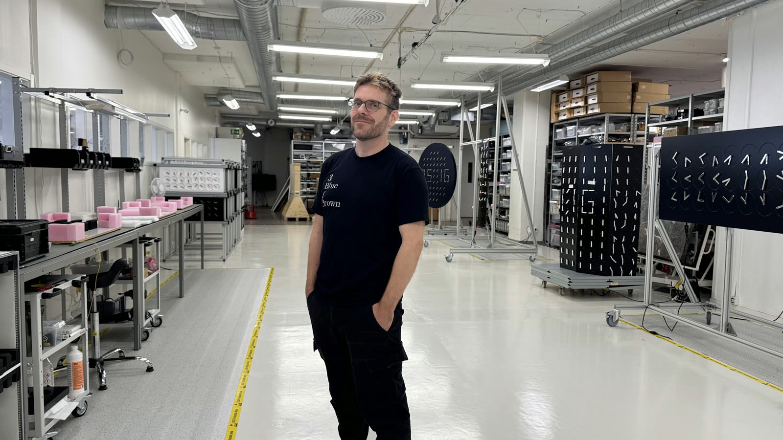 David Cox on the Humans since 1982 production floor. The panels on the right are ClockClock, mid-assembly.